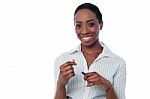 Young Smiling Corporate Woman Holding A Pen Stock Photo