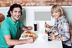 Young Smiling Couple Enjoying Lunch Stock Photo