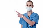 Young Smiling Doctor Pointing Copy Space Stock Photo