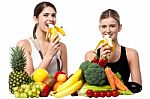 Young Smiling Girls Eating Banana Stock Photo