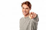 Young Smiling Guy Pointing You Out Stock Photo