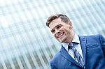 Young Smiling Man On Modern Building Background Stock Photo