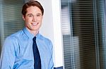 Young Smiling Relaxed Corporate Guy Stock Photo