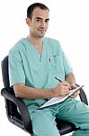 Young Surgeon sitting On Chair Stock Photo