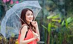 Young Thai Lady Standing With Under Umbrella Stock Photo