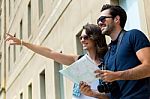 Young Tourist Couple Use Their Map And Pointing Where They Want Stock Photo