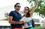 Young Tourist Couple Use Their Map And Pointing Where They Want Stock Photo