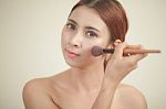 Young Woman Applying Makeup Stock Photo