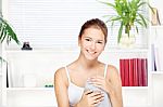 Young Woman At Home Sitting On The Sofa Stock Photo