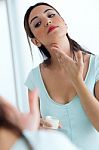 Young Woman Caring Of Her Skin Standing Near Mirror In The Bathr Stock Photo