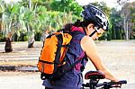 Young Woman Checking Mountain Bike Stock Photo