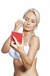 Young Woman Clean Face With Wet Wipes, Looking On Mirror In Hand Stock Photo