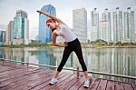 Young Woman Doing Stretching Exercise Stock Photo