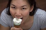 Young Woman Eating Ice Cream Stock Photo