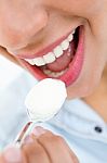 Young Woman Eating Yogurt Stock Photo