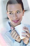 Young Woman Having A Coffee At The Kitchen Stock Photo