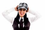 Young Woman In Cap Posing With Her Arms At Back Of Head Stock Photo