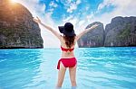 Young Woman In Red Bikini Sitting On The Beach Stock Photo