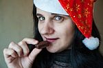 Young Woman In Santa Hat With Candy Stock Photo