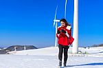 Young Woman Is A Happiness With Camera In Winter Of Sky And Winter Road With Snow And Red Dress Stock Photo