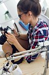 Young Woman Photographer Checking Previews On Camera In The Stud Stock Photo