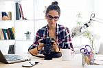 Young Woman Photographer Checking Previews On Camera In The Stud Stock Photo