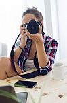 Young Woman Photographer Taking A Photography In The Studio Stock Photo