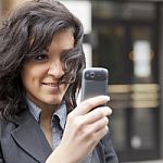 Young Woman Photographing With Cell Phone Stock Photo