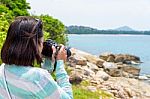 Young Woman Photography Near The Sea Stock Photo