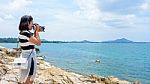 Young Woman Photography Near The Sea Stock Photo