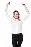 Young Woman Posing Arms Raised Over White Stock Photo