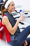 Young Woman Relaxing In The Gym After Making Exercise Stock Photo