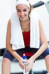 Young Woman Relaxing In The Gym After Making Exercise Stock Photo