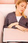 Young Woman Resting Sofa While Using Laptop Stock Photo