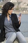 Young Woman Sends A Text Message Stock Photo