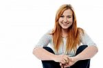 Young Woman Sitting On The Floor Stock Photo