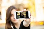 Young  Woman Taking A Photo With Her Phone Stock Photo