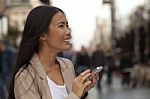 Young Woman Using A Phone Outside  Of Office Stock Photo