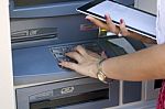 Young Woman Using Atm Machine Stock Photo