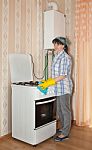 Young Woman Washes A Gas Stove Stock Photo