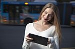 Young Woman With A Tablet On The Street Stock Photo