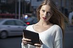 Young Woman With A Tablet On The Street Stock Photo