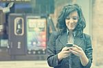 Young Woman With Cell Phone Walking Stock Photo