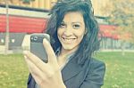 Young Woman With Cell Phone Walking Stock Photo