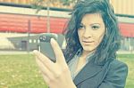 Young Woman With Cell Phone Walking Stock Photo