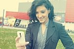 Young Woman With Cell Phone Walking Stock Photo