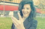 Young Woman With Funny Hair Smile Using Cell Phone Walking Stock Photo