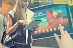 Young Woman With Tablet Computer Walking On Street Stock Photo