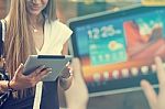 Young Woman With Tablet Computer Walking On Street Stock Photo