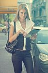 Young Woman With Tablet Computer Walking On Urban Street Stock Photo